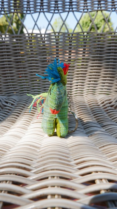 Green horse keychain with blue, red, green tail