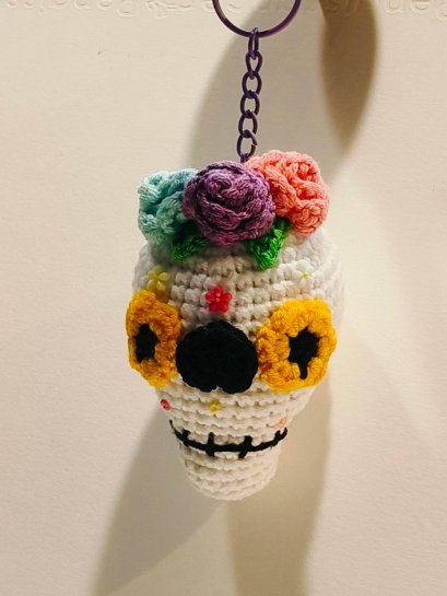 White skull keychain with yellow eye