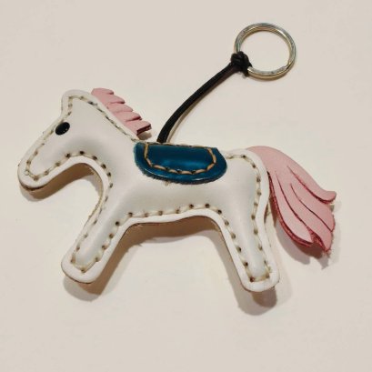 White horse keychain with a pink tail