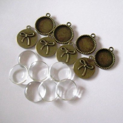 หัวซิปทองดำ พร้อมกระจก แบบกลมด้านหลังลายโบว์ ขนาด 18 mm. 8 ชุด/set