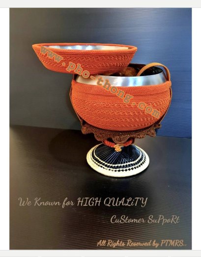 Golden-yellow alms bowl set with stand on a dark background