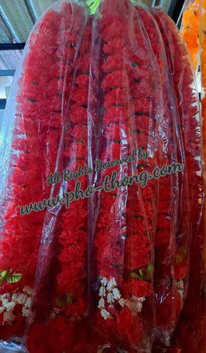 Multiple red marigold fabric garlands packed closely in clear plastic sleeves