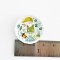 Miniature ceramic plates with adorable gnome and nature illustrations, ideal for enchanted dollhouse or woodland-themed setups.