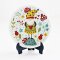 Miniature ceramic plates with adorable gnome and nature illustrations, ideal for enchanted dollhouse or woodland-themed setups.