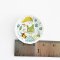 Miniature ceramic plates with adorable gnome and nature illustrations, ideal for enchanted dollhouse or woodland-themed setups.