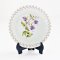 Miniature ceramic decorative plates featuring intricate purple floral designs, perfect for dollhouse kitchens, collectibles, and elegant tiny decor.