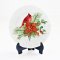 Miniature Christmas plates with cardinal designs, perfect for dollhouse holiday decor and adding festive cheer to miniature scenes.