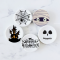 Handcrafted miniature Halloween-themed ceramic plates featuring spooky designs like haunted houses, spider webs, and skulls, perfect for dollhouse decor.