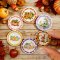 Handcrafted miniature ceramic plates with pumpkin and Halloween-themed designs, featuring gingham and polka dot patterns, perfect for fall and spooky dollhouse decor.