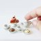 Miniature White Ceramic Tea Set with Pastries and Cookies