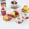 Handcrafted miniature dessert set with a colorful cake, pastries, pancakes, orange juice, and Fanta drinks, perfect for dollhouse bakery or kitchen displays.