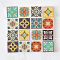 Handcrafted miniature ceramic tiles with intricate aqua, orange, and black patterns. Set of 16 pieces, perfect for 1:12 scale dollhouse decor.