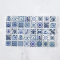 Set of 40 miniature ceramic tiles featuring intricate blue Delft-inspired patterns. Perfect for 1:12 scale dollhouse decor.