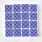 Set of 16 miniature ceramic tiles featuring a bold blue geometric floral pattern. Perfect for 1:12 scale dollhouse decor.