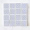 Set of 16 miniature ceramic tiles featuring a bold blue geometric floral pattern. Perfect for 1:12 scale dollhouse decor.