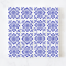 Set of 16 miniature ceramic tiles featuring a bold blue geometric floral pattern. Perfect for 1:12 scale dollhouse decor.