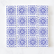 Set of 16 miniature ceramic tiles featuring a bold blue geometric floral pattern. Perfect for 1:12 scale dollhouse decor.