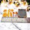 Miniature bread and donuts set in a wooden crate for dollhouse bakery or kitchen display.