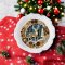 Handcrafted Christmas-themed miniature plate with intricate reindeer design, perfect for dollhouse holiday decor.