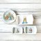 Set of four miniature Peter Rabbit-themed ceramic dishes, featuring a plate and trays, perfect for dollhouse decor or collectible gifts.