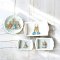 Set of four miniature Peter Rabbit-themed ceramic dishes, featuring a plate and trays, perfect for dollhouse decor or collectible gifts.