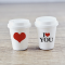 Set of two miniature coffee cups with love-themed designs, featuring 'I ❤️ YOU' and a heart, perfect for Valentine's Day dollhouse decor