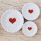 Set of three miniature ceramic plates with red heart designs, sizes 4.5 cm, 3.5 cm, and 2.8 cm, perfect for Valentine's Day dollhouse decor.