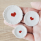 Set of three miniature ceramic plates with red heart designs, sizes 4.5 cm, 3.5 cm, and 2.8 cm, perfect for Valentine's Day dollhouse decor.