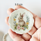 miniature decorative plates featuring adorable Easter bunny illustrations with floral backgrounds. Ideal for dollhouse collectors and festive displays.