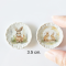 miniature decorative plates featuring adorable Easter bunny illustrations with floral backgrounds. Ideal for dollhouse collectors and festive displays.