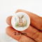 miniature decorative plates featuring adorable Easter bunny illustrations with floral backgrounds. Ideal for dollhouse collectors and festive displays.