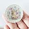 miniature decorative plates featuring adorable Easter bunny illustrations with floral backgrounds. Ideal for dollhouse collectors and festive displays.