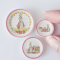 A charming 3-piece miniature plate set featuring Easter bunny designs with pastel pink borders, floral accents, and decorative eggs—perfect for dollhouse displays and festive decor.