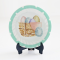 A delightful 4-piece miniature plate set featuring Easter bunny designs with pastel polka-dot borders, decorative eggs, and a cute carrot—perfect for dollhouse displays and festive decor.