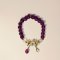 Purple Beaded Bracelet with White Flower Charm