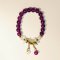 Purple Beaded Bracelet with White Flower Charm