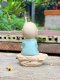 Three ceramic novice monk statues