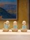 Three ceramic novice monk statues