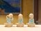 Three ceramic novice monk statues