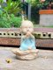 Three ceramic novice monk statues