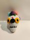 White skull keychain with yellow eye