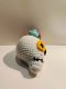 White skull keychain with yellow eye