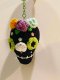 Black skull keychain with green eye