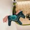 Green horse keychain with a pink tail