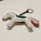 White horse keychain with a pink tail