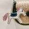 White horse keychain with a pink tail