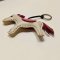 Light gray horse keychain with a dark red tail