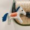 White horse keychain with a blue tail