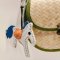 White horse keychain with a blue tail