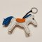White horse keychain with a blue tail